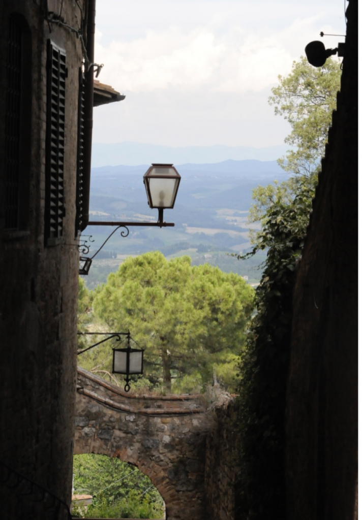 view between buildings of Italian countryside with a lantern